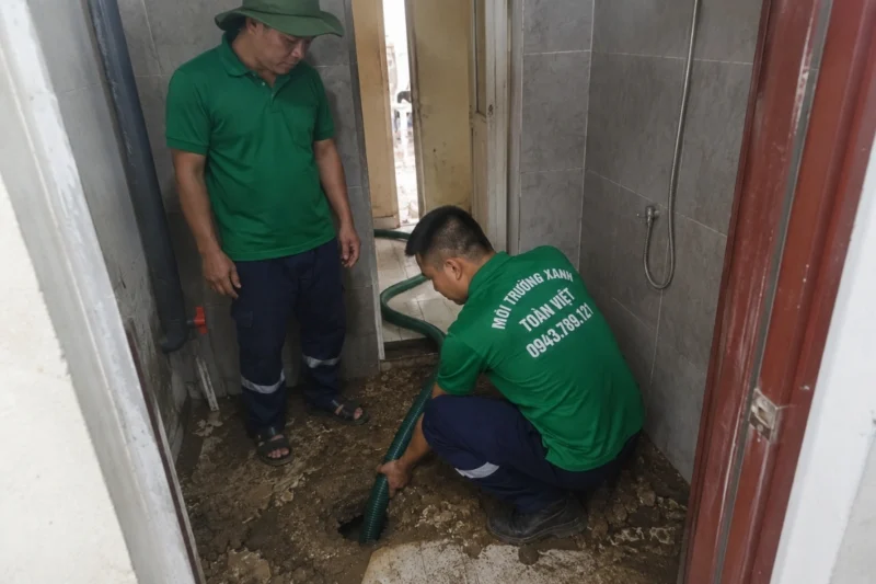 Nhân viên môi trường đang đưa ống hút vào trong nhà