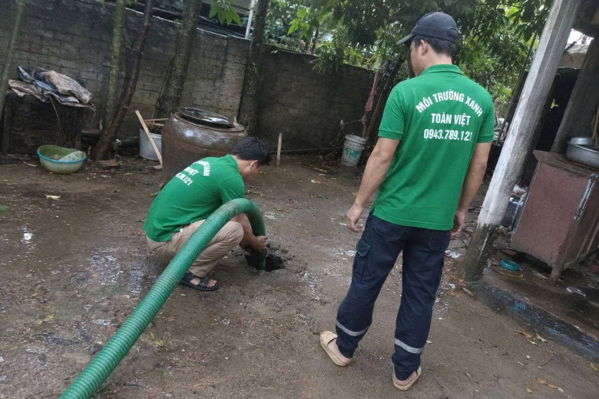 Nhân viên kéo ống hút chuyên dụng qua phòng khách