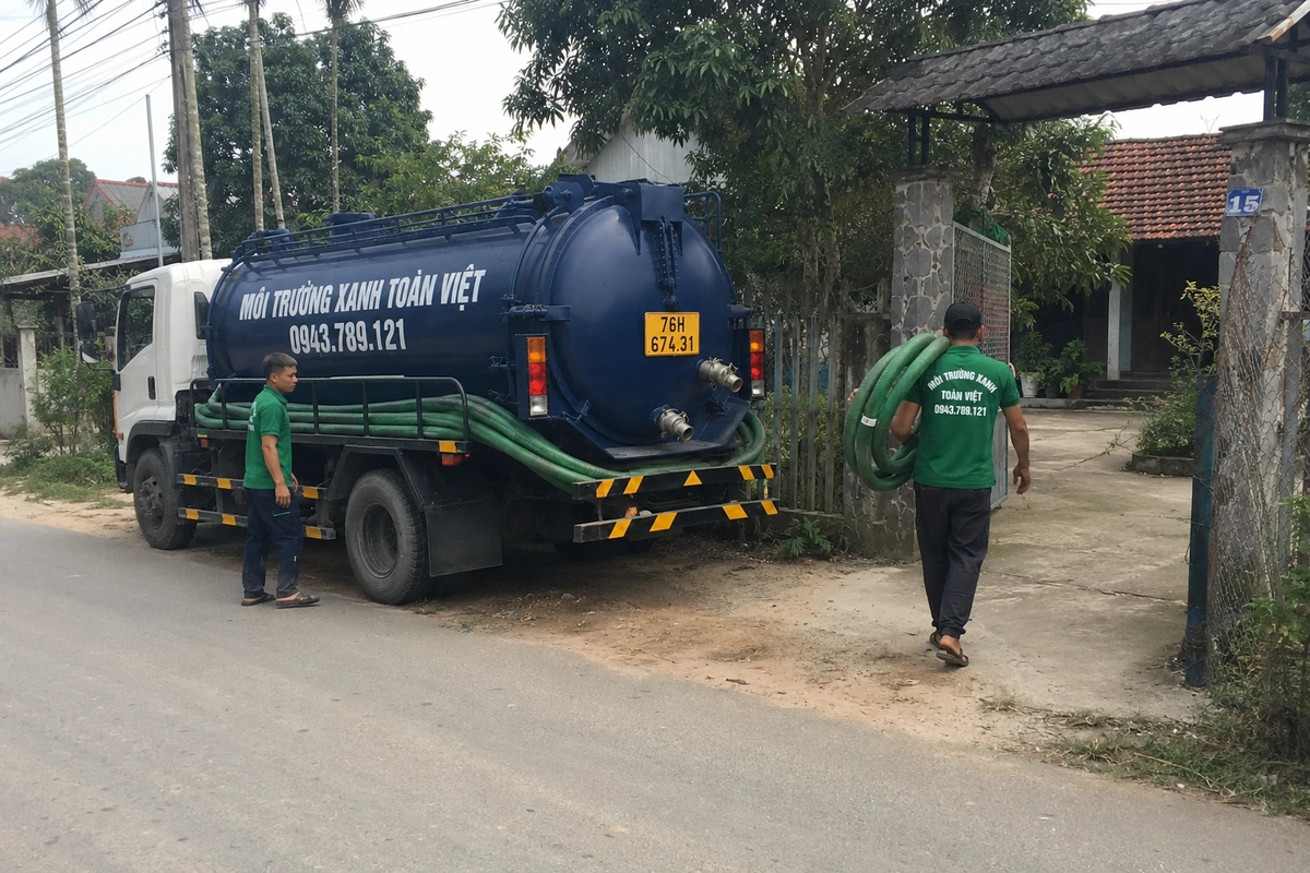 Hút Hầm Cầu Quảng Ngãi: Xem Đường Vào Rồi Mới Điều Xe 20 Nhân viên vác cuộn ống hút từ xe vào nhà khách tại Quảng Ngãi