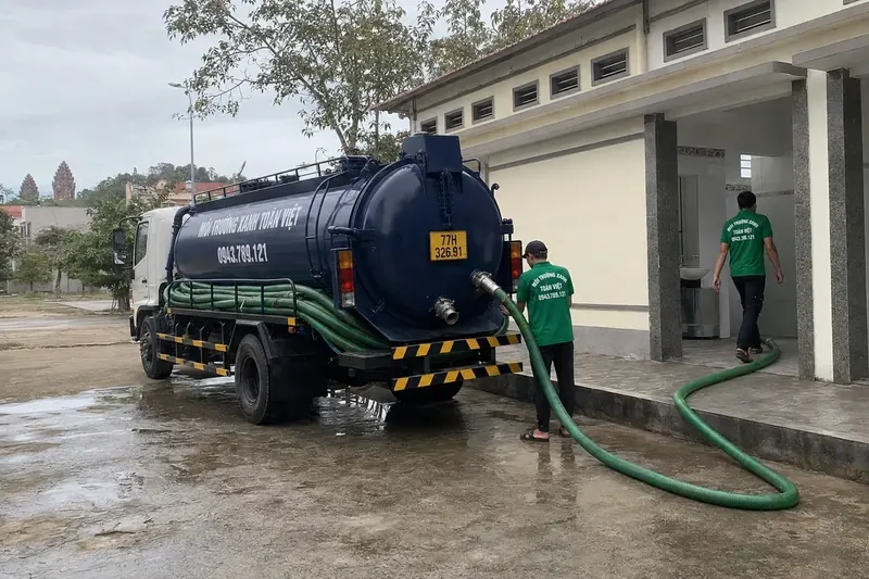 Hút hầm cầu Bình Định – Môi Trường Xanh Toàn Việt 46 Xe bồn cùng tuyến ống tại sân phía trước